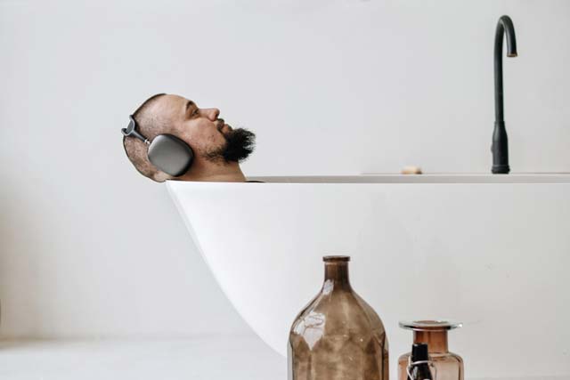 man relaxing in bathtub