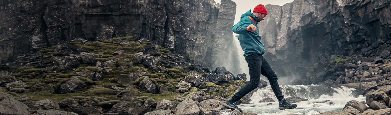 man jumping across river
