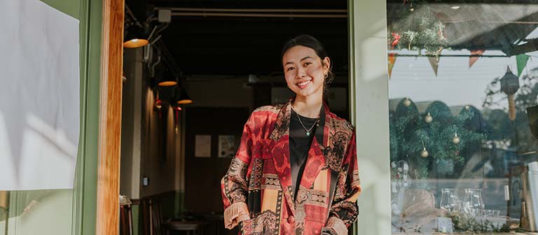Woman standing in front of her storefront