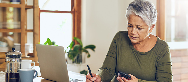 woman sitting at the table working on finances