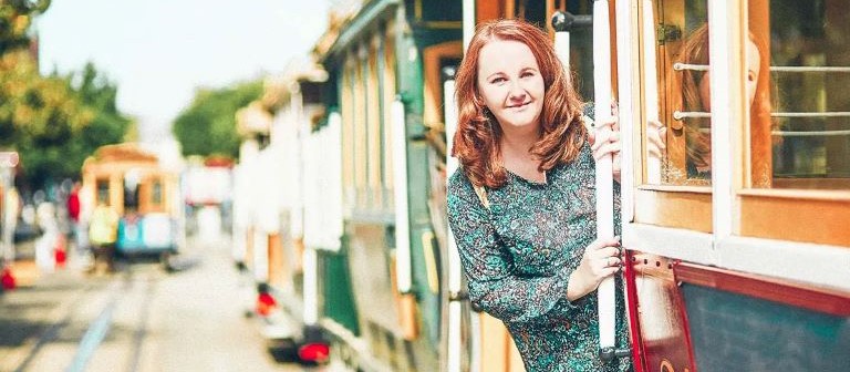 Woman leaning out of train car