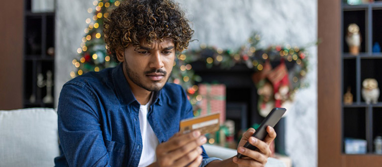 confused man looking at his credit card