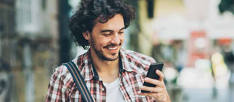 Man using smartphone outdoors