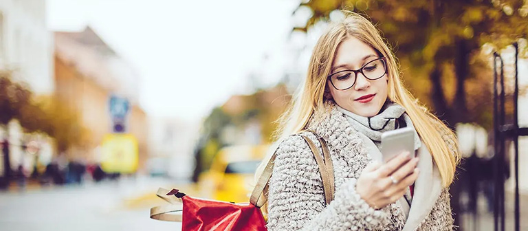 woman on her phone while walking outside