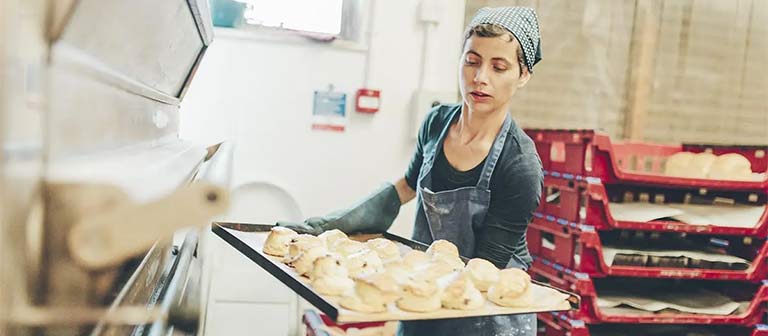Woman baking rolls