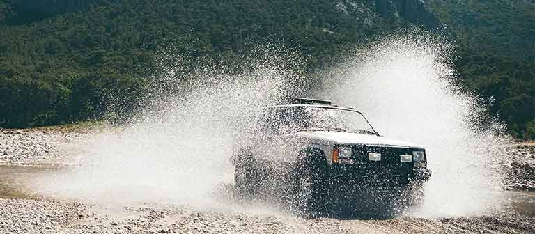 Jeep driving through a river