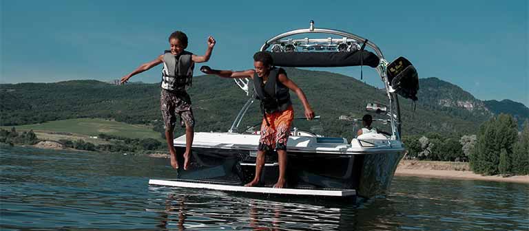 Kids jumping off a boat