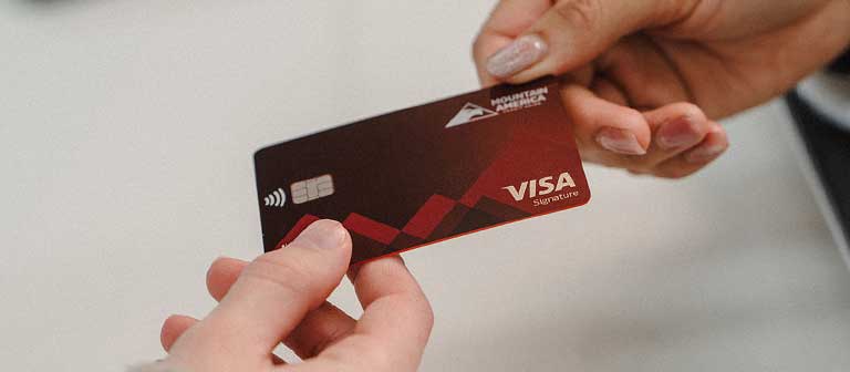 Employee passing a credit card to a member