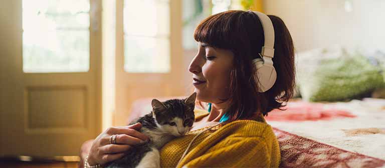 Relieved woman holding pet cat