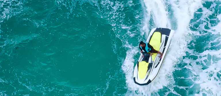 person riding watercraft in ocean