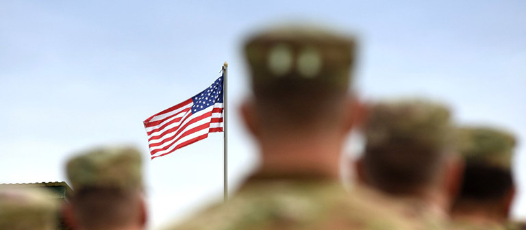 Soldiers with American flag in background