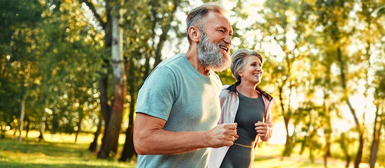 Mature couple jogging outdoors