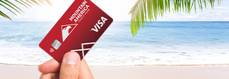 Mountain America credit card with beach scene in the background