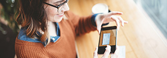 Young woman depositing a check with her phone