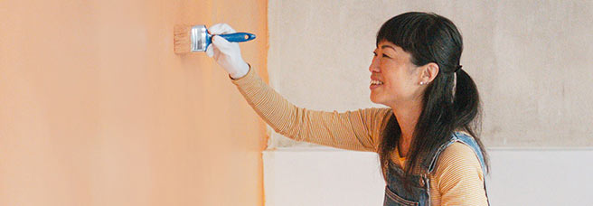 Woman painting a wall