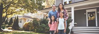 happy family in front of their house