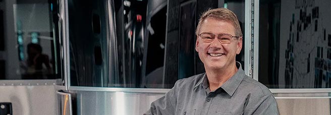 Man standing in front of an airstream trailer