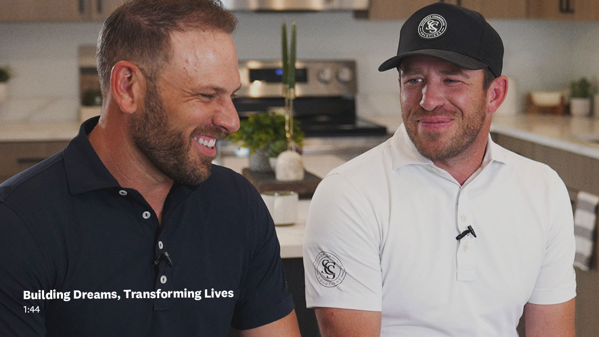 Two men in a kitchen talking